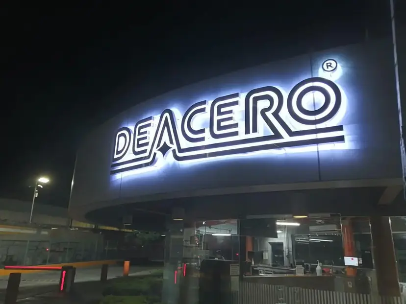 DEACERO 3D letters glowing at night with a rear halo: an LED illuminated sign built and installed by AVM